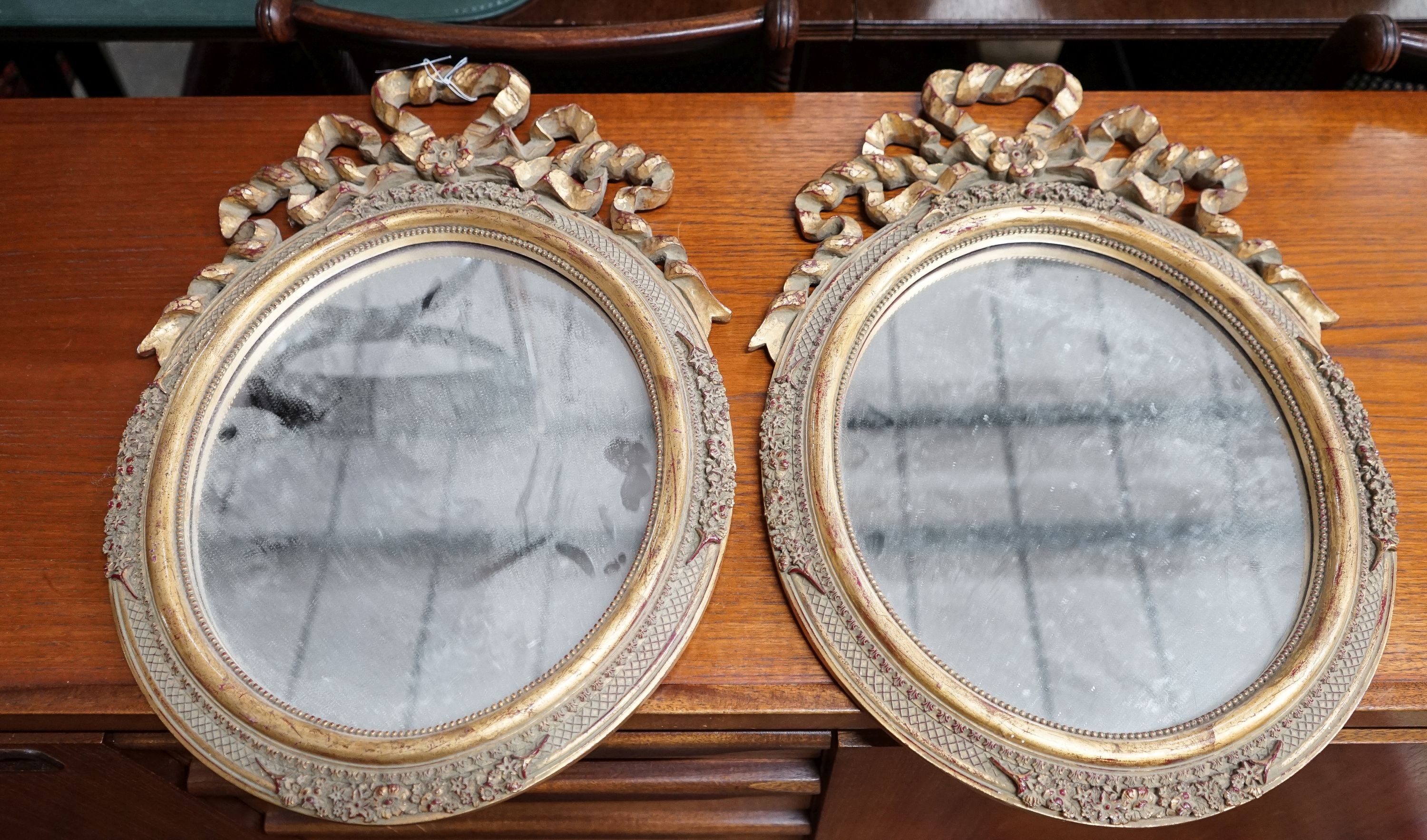 A pair of Victorian style oval gilt framed wall mirrors, width 37cm, height 52cm